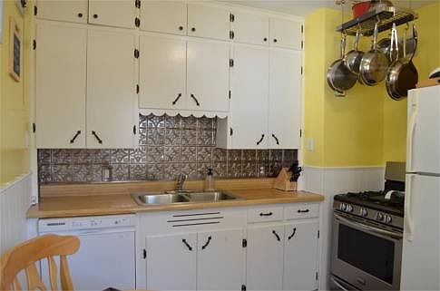 Adorable and fresh eat-in kitchen with new flooring, newer range and dishwasher.