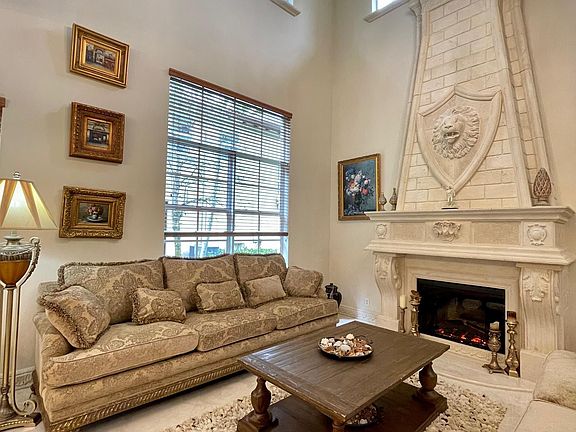 Formal living room - stone fireplace operated by natural gas