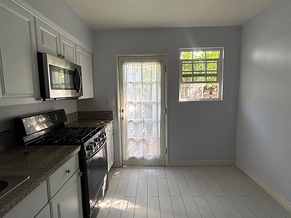 Full kitchen with oven, microwave, refrigerator, granite countertops, and lots of cabinet storage