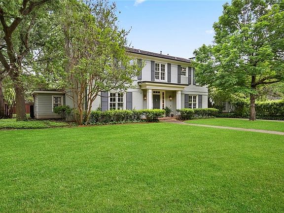 This stately home has curb appeal plus with a large front yard space and extensive landscaping!
