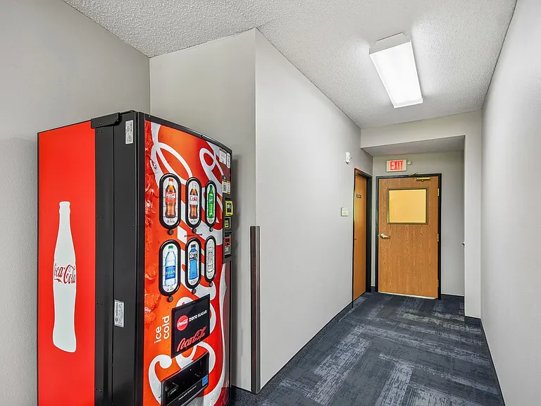Convenience meets comfort at Mill Pond Apartments. This inviting hallway features a handy vending machine, ensuring snacks and drinks are just steps away. Elevate your living experienceschedule your tour today!