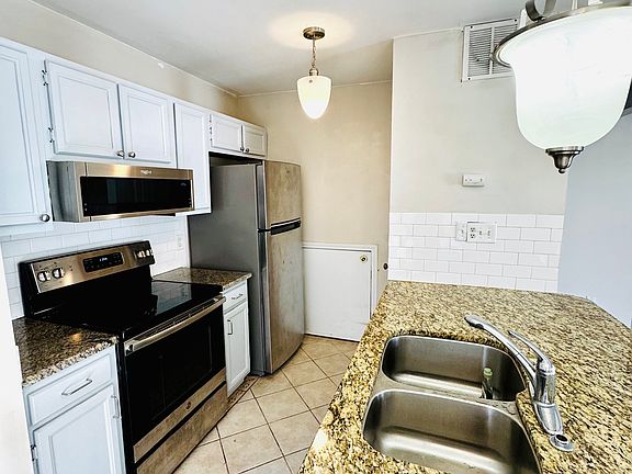 Kitchen with stainless steel appliances + pantry