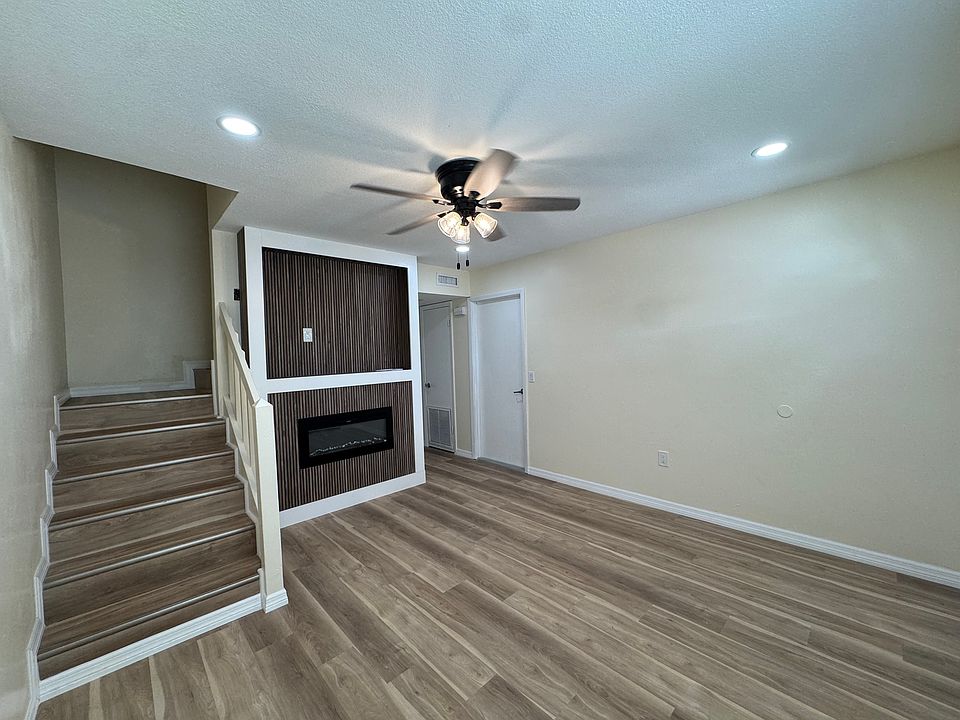Living room area with staircase leading up to the 3 bedrooms and 2 bathrooms.