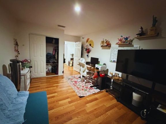 Spacious bedroom with room for a workspace and generous closet storage.