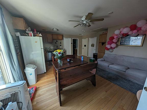 Unit #2 living area with hardwood floors and ceiling fan