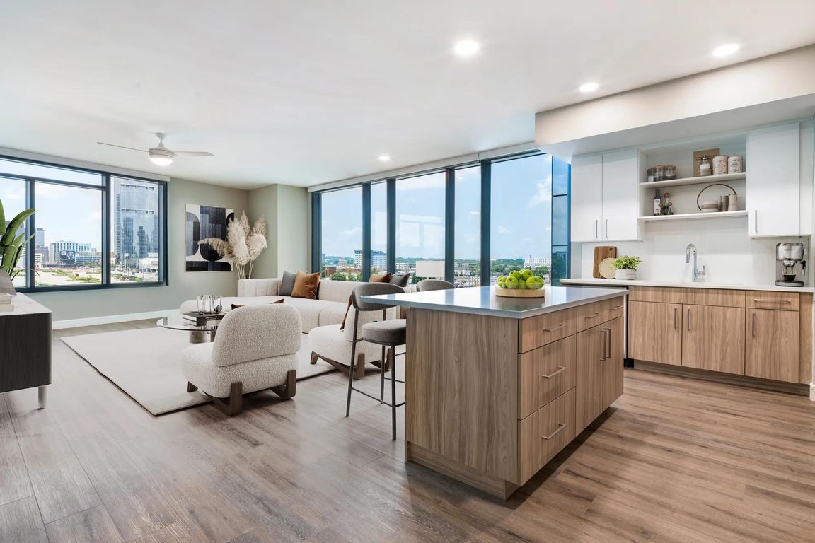 Enjoy a modern kitchen with 42" soft-close cabinetry with under cabinet lighting, quartz counters, and open shelving for added function and style.