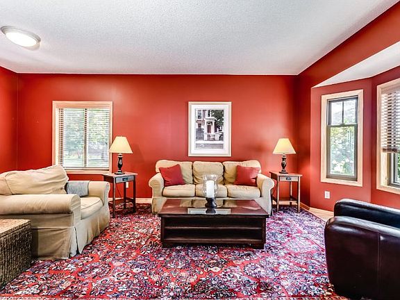 Informal living/dining room area with a bay window and hardwood floors.