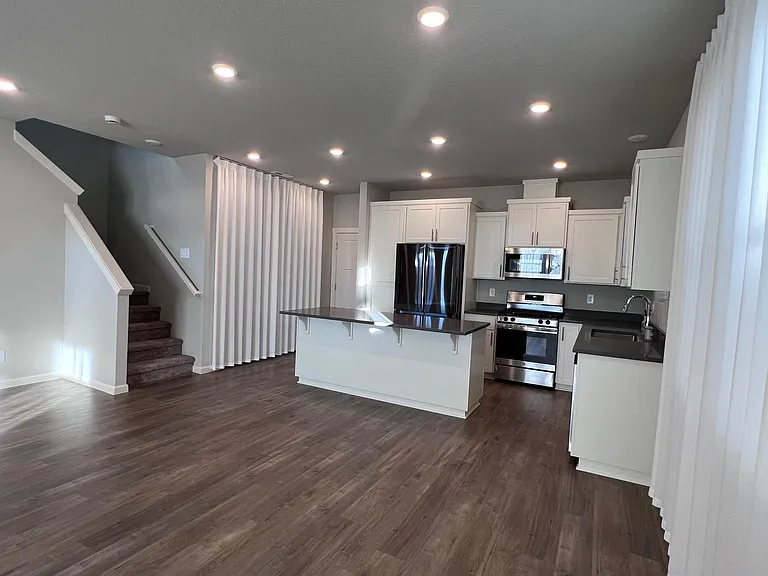 kitchen comes with a big island and modern applicances