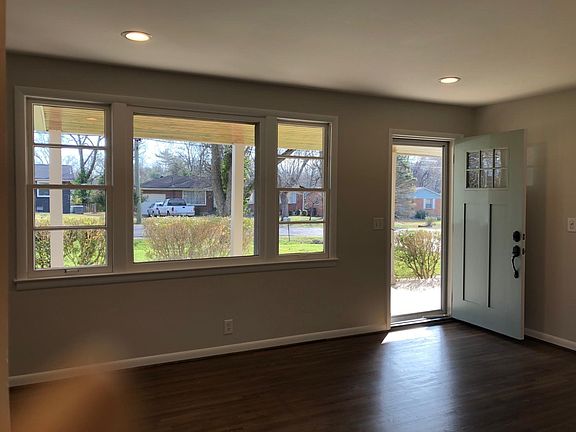Living Room has recess lights and triple windows for great light with blinds and hardwood floors
