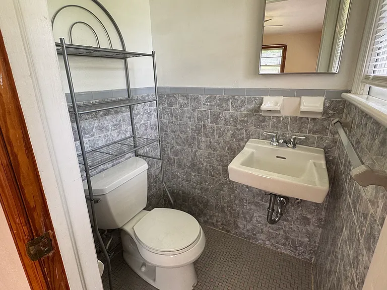 Private half bath in primary bedroom.