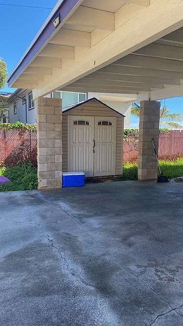 Covered carport for two vehicles and storage shed