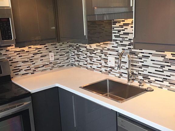 STAINLESS STEEL SINK AND QUARTZ COUNTERTOPS