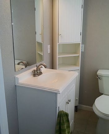 New bath vanity and large well lit mirror