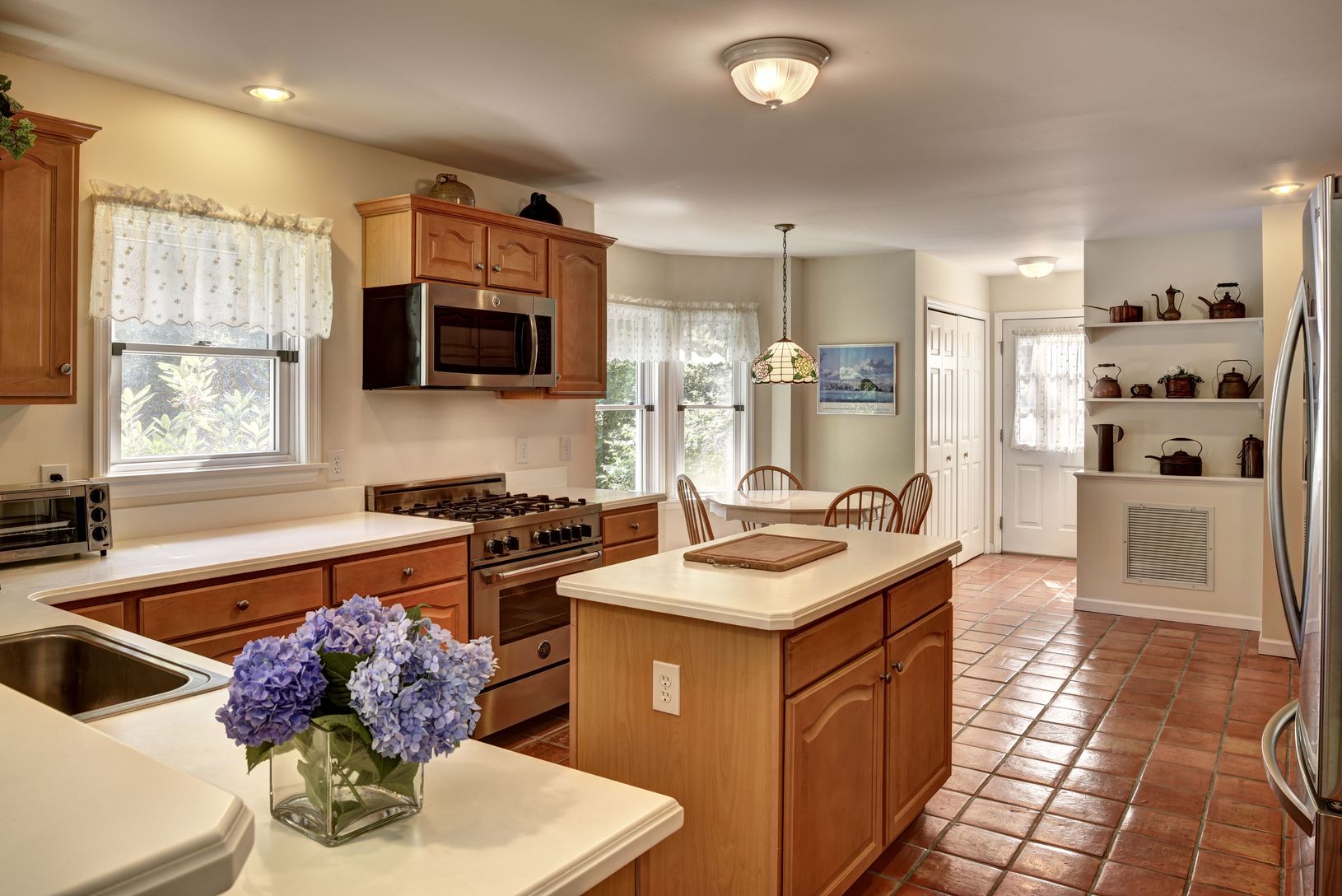 Kitchen with Corian countertops and stainless steel appliances, including Bertazzoni range