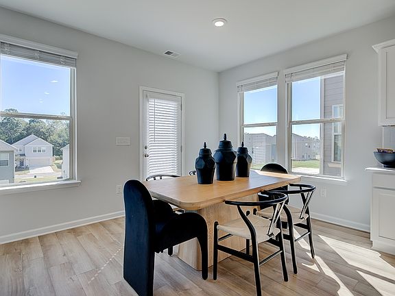 Open breakfast area in new construction home with expansive windows and natural light.
