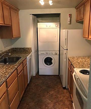 full size washer and dryer in kitchen: self cleaning oven, microwave, refrigerator, dishwasher and disposal.