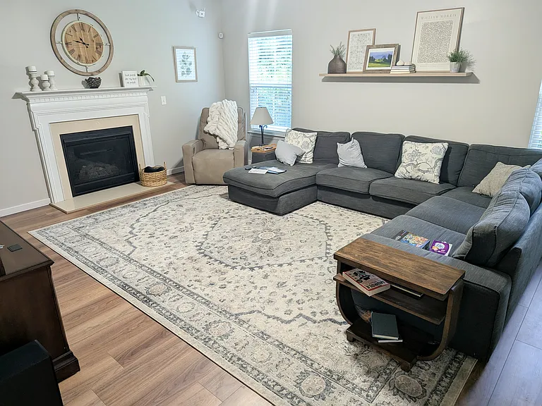Large family room with gas fire place (shows new lamanate flooring)