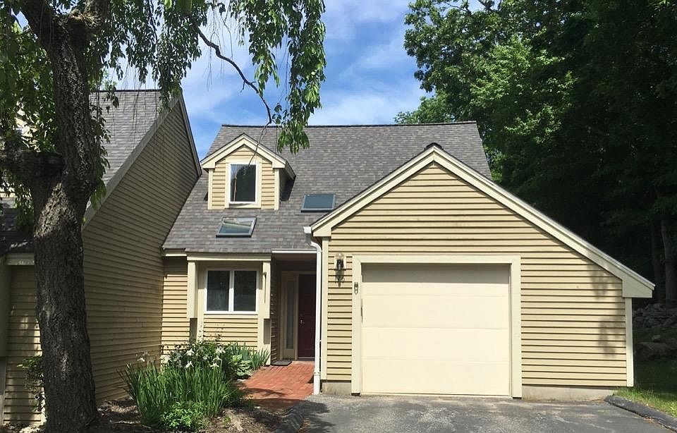 The front side of the condo, end unit, one-car parking garage plus two designated guest parking