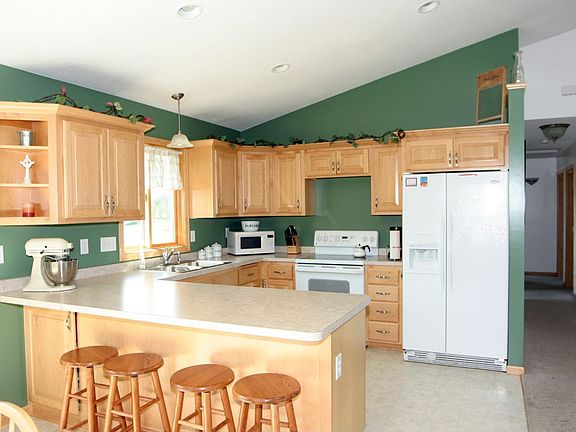 Kitchen features all maple cabinets and vaulted ceilings.