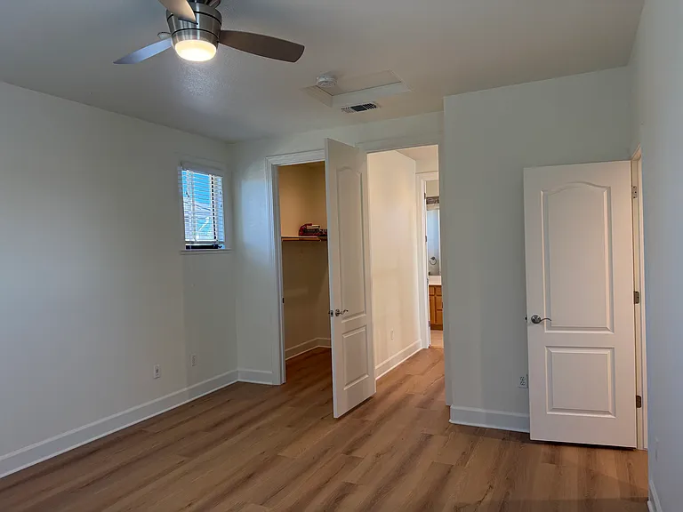Fourth bedroom is on the third floor with a bathroom across the hallway. The fourth bedroom features a ceiling fan with 2 walk-in closets.