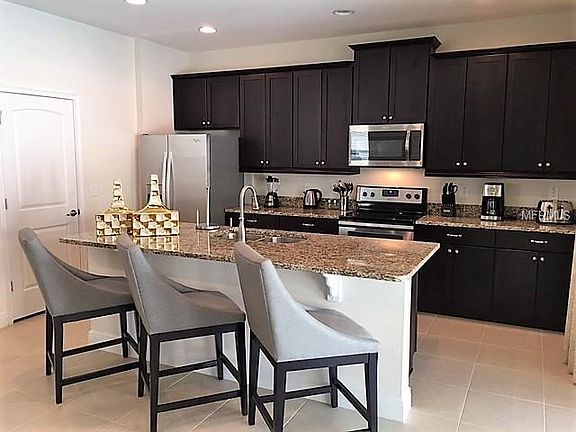 Granite counter tops, stainless steel appliances, and extended cabinets completes this open kitchen.