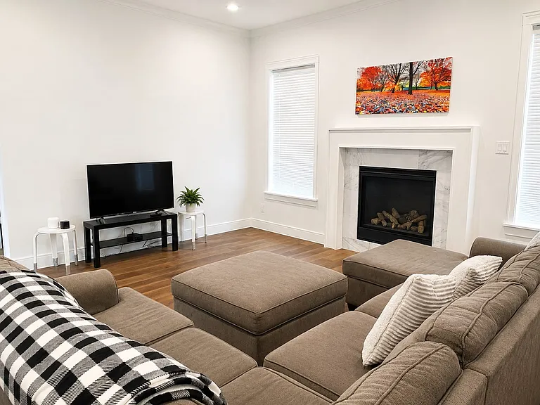 Living area featuring a gas fireplace with a marble surround and white mantel