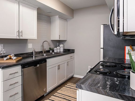 A sleek and modern kitchen featuring stainless steel appliances, ample storage, and elegant countertops.