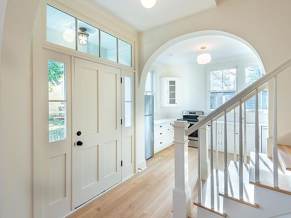 Upon entering the front door, the kitchen is to your left, and the living room is to your right. Straight ahead is the staircase that leads to the second and third floors.