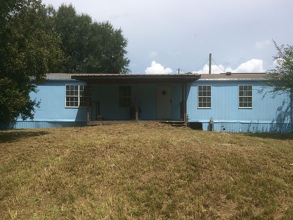 Back of home with covered back porch and private yard