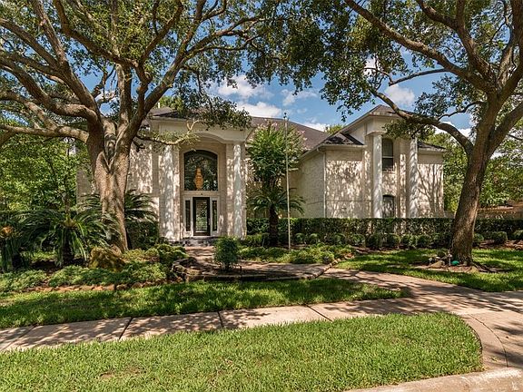 This distinctive home is located in Estate section five of Bay Oaks.