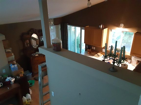 upstairs view of kitchen and door to two car attached garage. sliding door to spacious patio and backyard.