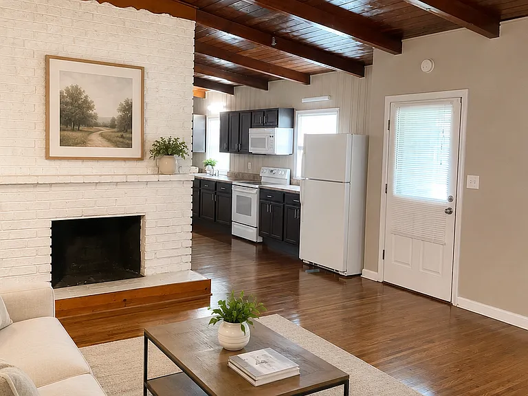 Virtually staged to illustrate furniture placement; furnishings are not included. Features wood flooring, an exposed wood ceiling, large windows and a decorative fireplace feature.