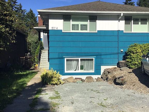 Front of the duplex with parking spot. This unit is on the top floor. The enterance is on the left side of the house and parking is in the front of the the house.