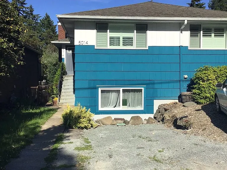 Front of the duplex with parking spot. This unit is on the top floor. The enterance is on the left side of the house and parking is in the front of the the house.