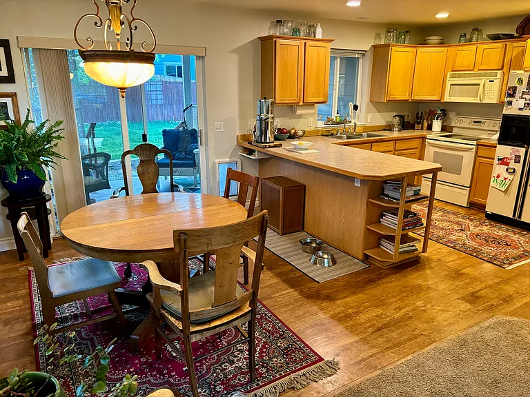 Dining room to the back porch and yard, kitchen