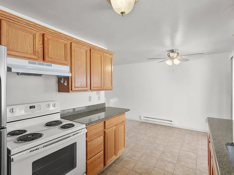 Kitchen looking to dining area with ceiling fan
