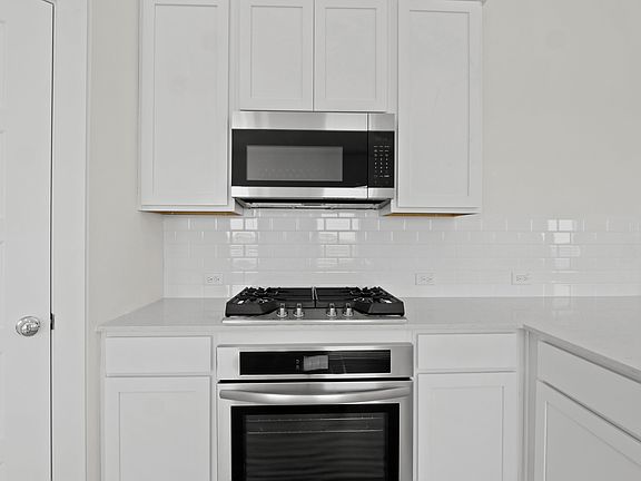 Kitchen in the Pecan II home plan by Trophy Signature Homes - REPRESENTATIVE PHOTO