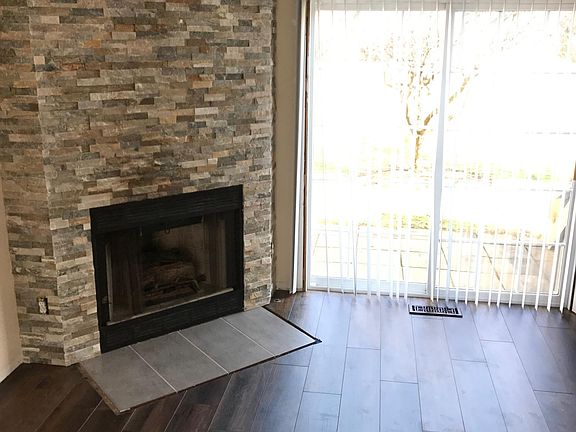 Gorgeous Stacked Stone Fireplace. Hardwood Floors