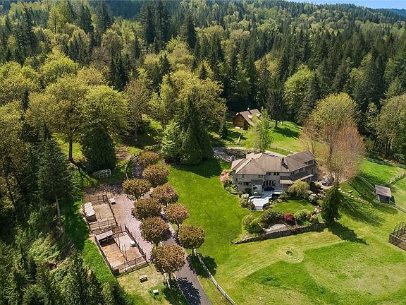 The property is lush with old growth and second growth Douglas Fir, Maple, Alder, Hemlock, Cedar and Yew Trees. It offers fenced and cross fenced pastures, fruit trees, fenced gardens with ever-bearing raspberries, blueberries, strawberries & rhubarb, 3 barns, a greenhouse, 3 coops, dog run and so much more.