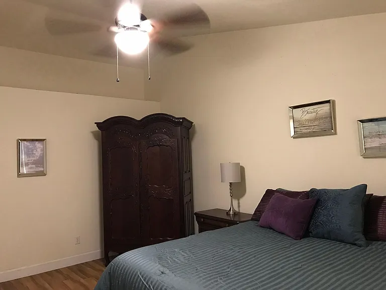 Master bedroom, California King bed, has master bath and glass doors to 4 seasons room. Very large. Fully furnished