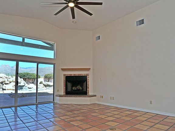 Family room, view of pool. Wood burning fireplace, adjacent to kitchen