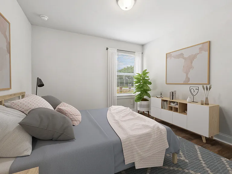 Secondary bedroom with queen size bed and large window letting in a ton of natural light.