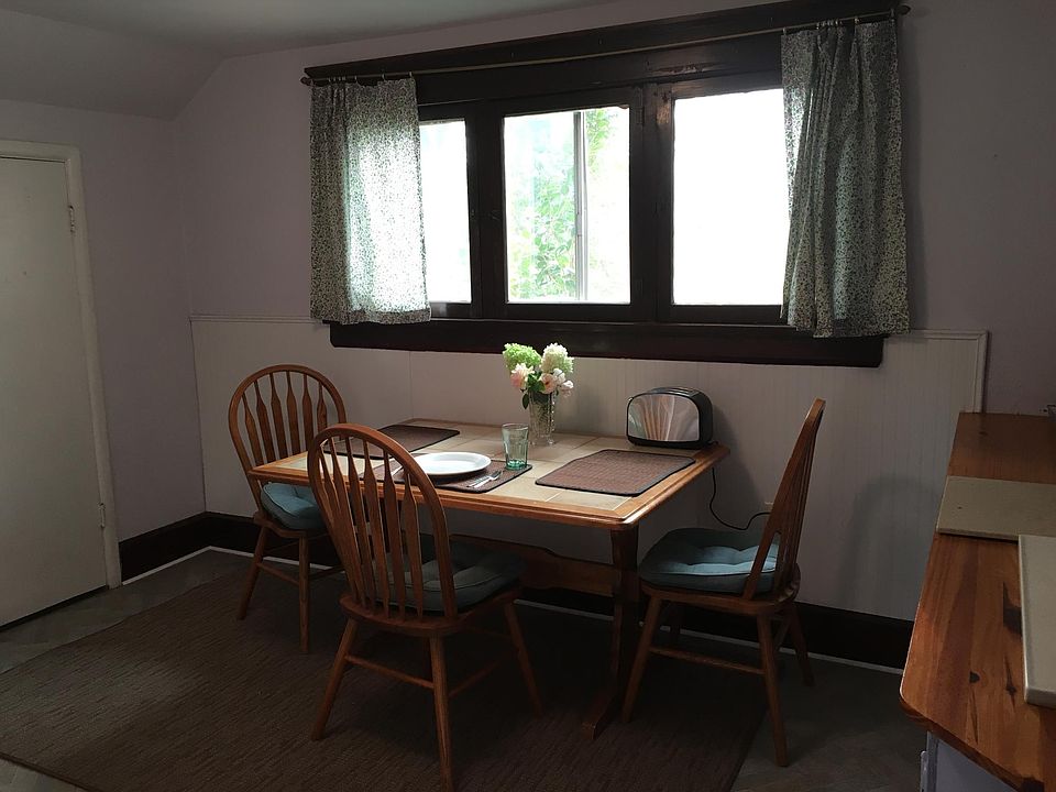 kitchen with small fridge, hot plate, counter top oven, micr