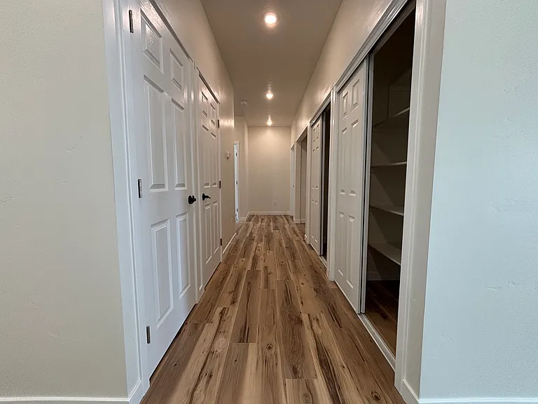 Hallway with coat closet, 3 other storage closets
