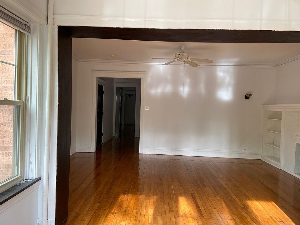 Looking into living room from sunroom. Ceiling fan