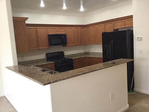 Kitchen with granite countertop. Refrigerator included.