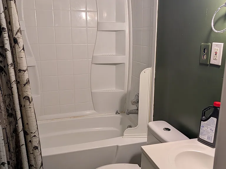 Full bathroom with bathtub, sink and commode
