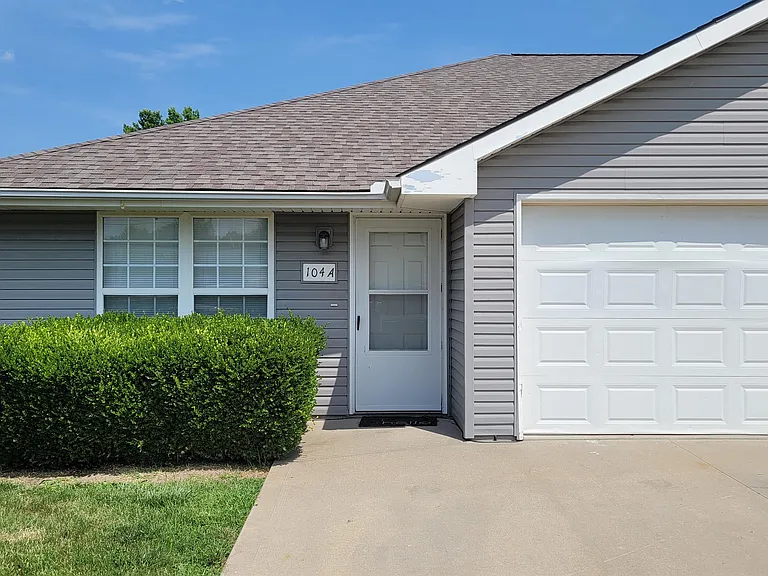 Unit A front entrance with single-car garage with opener.
