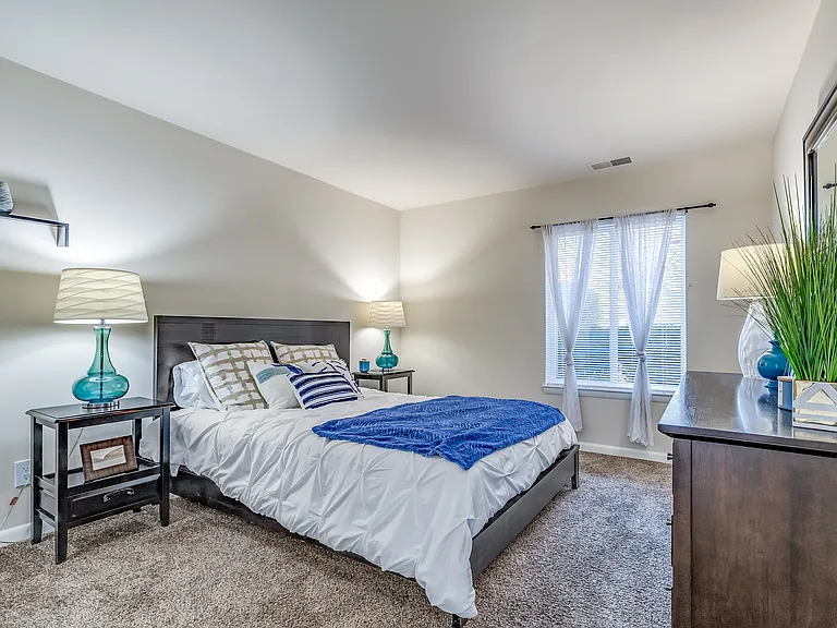Experience the relaxation of this cozy modern bedroom, featuring chic decor and abundant natural light.