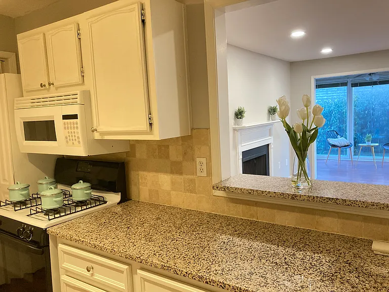 Kitchen with granite countertops and an opening to the livingroom